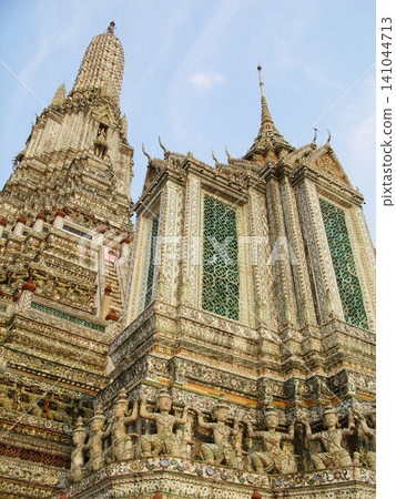 Architectural details and intricate porcelain decorations of the iconic Wat Arun central prang in Bangkok, Thailand. 141044713