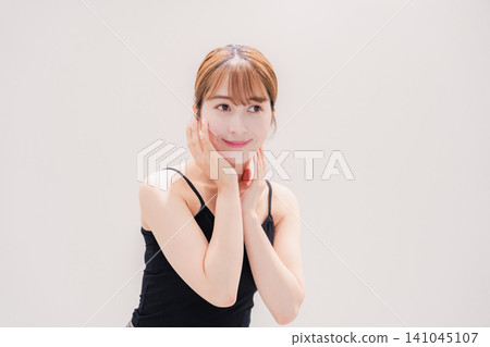 A young woman with light-colored hair who is getting beauty treatments. A young woman with light-colored hair who is getting beauty treatments. 141045107