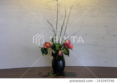 A traditional ikebana arrangement featuring camellias and willows. A traditional ikebana arrangement featuring camellias and willows. 141045546