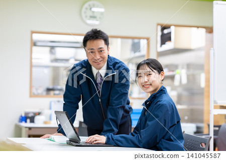 Staff members having a meeting in front of the kitchen Staff members having a meeting in front of the kitchen 141045587