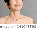 A senior Asian woman smiles as she looks towards the future. 141045598