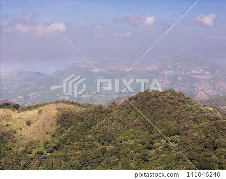 View of mountains and hills in a rural area during daytime View of mountains and hills in a rural area during daytime 141046240