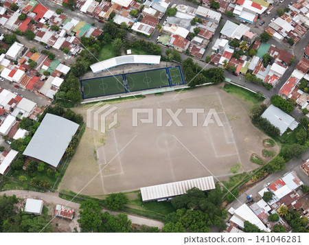 Soccer field and neighborhood seen from above during daytime Soccer field and neighborhood seen from above during daytime 141046281
