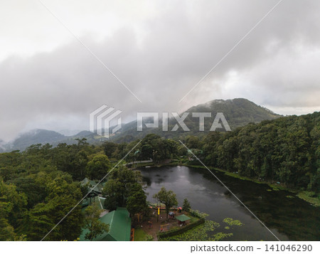 Cloudy day over a forest and lake in a mountainous area Cloudy day over a forest and lake in a mountainous area 141046290