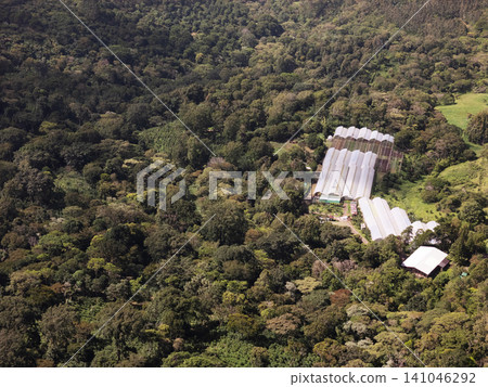 Farm area surrounded by forest in a mountainous region Farm area surrounded by forest in a mountainous region 141046292