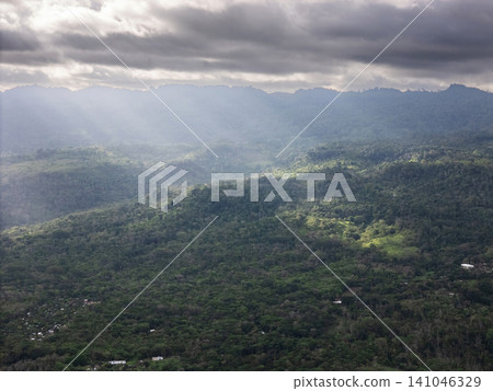 Mountains and valleys seen from high above on a cloudy day Mountains and valleys seen from high above on a cloudy day 141046329