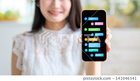 A woman is looking at messages on her smartphone. A woman is looking at messages on her smartphone. 141046341