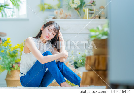 Young woman relaxing in a room Young woman relaxing in a room 141046405