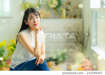 Woman looking out of the window Woman looking out of the window 141046407