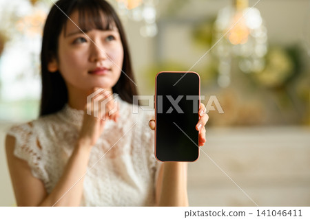 A young woman with a smartphone A young woman with a smartphone 141046411