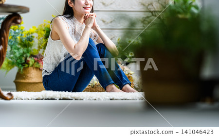 Young woman relaxing in a room 141046423