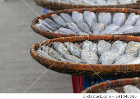 Sun dried fish arranged traditional bamboo baskets for natural preservation showcasing seafood processing local market culture artisanal food production Sun dried fish arranged traditional bamboo baskets for natural preservation showcasing seafood processing local market culture artisanal food production 141046586