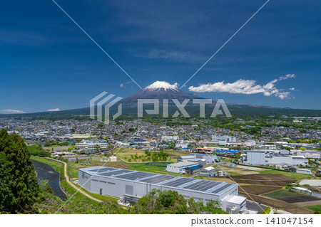 A view of Mount Fuji and the cityscape of Fuji City. A view of Mount Fuji and the cityscape of Fuji City. 141047154