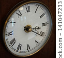 The afternoon time shown on the old mantel clock 141047233