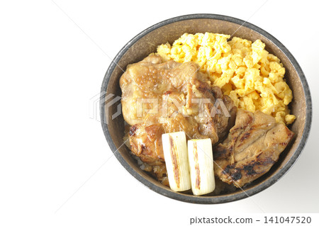 A bowl of scrambled eggs, grilled green onions, and charcoal-grilled chicken photographed against a white background. A bowl of scrambled eggs, grilled green onions, and charcoal-grilled chicken photographed against a white background. 141047520