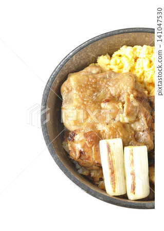 A bowl of scrambled eggs, grilled green onions, and charcoal-grilled chicken photographed against a white background. A bowl of scrambled eggs, grilled green onions, and charcoal-grilled chicken photographed against a white background. 141047530
