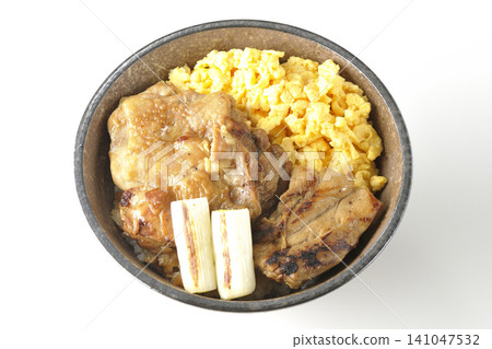 A bowl of scrambled eggs, grilled green onions, and charcoal-grilled chicken photographed against a white background. A bowl of scrambled eggs, grilled green onions, and charcoal-grilled chicken photographed against a white background. 141047532