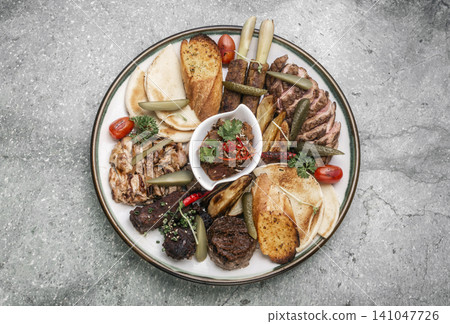 mixed grilled meat bbq gourmet big plate on restaurant table mixed grilled meat bbq gourmet big plate on restaurant table 141047726