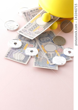 A coin purse and toy money A coin purse and toy money 141048715