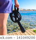 Close-up of a diving mask held in a woman's hand, ready for underwater adventure 141049200