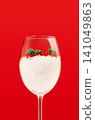 Christmas Gift Boxes in Wine Glass Filled with Artificial Snow on Red Background with Copy Space. Perfect for Christmas Holiday Advertising. Vertical Photography. 141049863