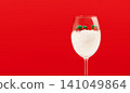 Christmas Gift Boxes in Wine Glass Filled with Artificial Snow on Red 141049864