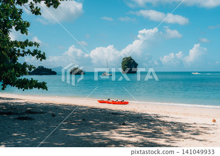 Beautiful Tropical Beach with Clear Blue Water and Limestone Islands in Krabi Beautiful Tropical Beach with Clear Blue Water and Limestone Islands in Krabi 141049933
