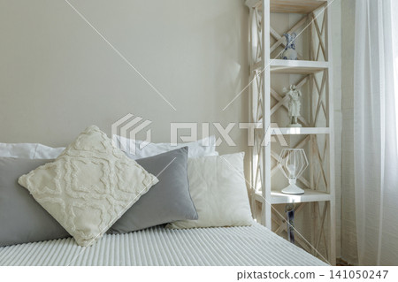 Cozy Bedroom Interior with Wooden Shelving and Pillows Cozy Bedroom Interior with Wooden Shelving and Pillows 141050247