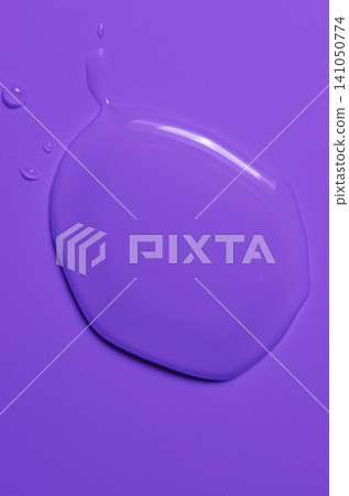A transparent cosmetic product on a purple background. A transparent cosmetic product on a purple background. 141050774
