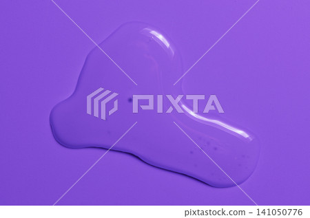 A transparent cosmetic product on a purple background. A transparent cosmetic product on a purple background. 141050776