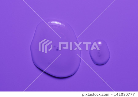 A transparent cosmetic product on a purple background. A transparent cosmetic product on a purple background. 141050777