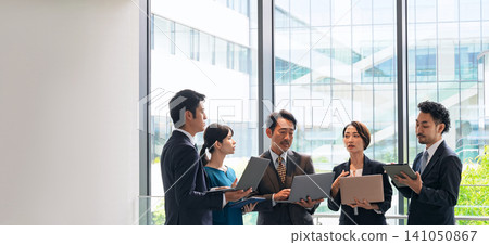 A group of business people having a meeting with digital devices 141050867
