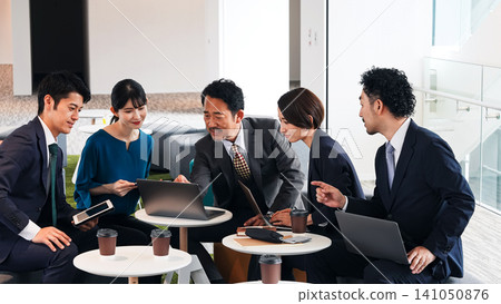 Group of business people meeting in lobby Group of business people meeting in lobby 141050876