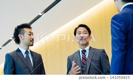 Group of executive business people having a conversation in a lobby Group of executive business people having a conversation in a lobby 141050925