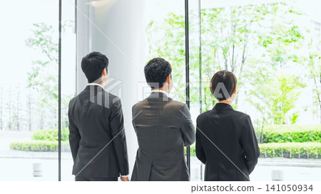 Business group looking out from the office Business group looking out from the office 141050934