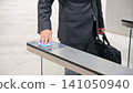 Business person passing through the entrance gate 141050940