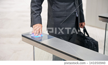Business person passing through the entrance gate 141050940