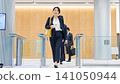 Business person passing through the entrance gate 141050944