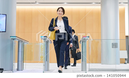 Business person passing through the entrance gate Business person passing through the entrance gate 141050944