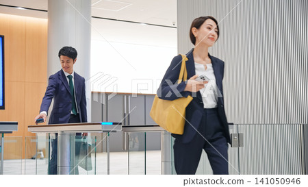 Business person passing through the entrance gate 141050946