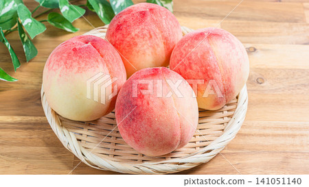 Fresh white peaches in season, arranged in a basket, a taste of summer. Fresh white peaches in season, arranged in a basket, a taste of summer. 141051140