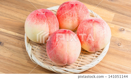 Fresh white peaches in season, arranged in a basket, a taste of summer. Fresh white peaches in season, arranged in a basket, a taste of summer. 141051144