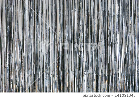 Shiny metallic surface with vertical stripes creating an abstract pattern in bright light 141051343
