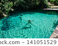 boy swims in natural pool formed by a spring. turquoise and crystalline fresh water into Amazon rainforest 141051529
