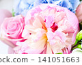Beautiful spring bouquet featuring pink peonies and blue hydrangeas arranged elegantly in a vase 141051663