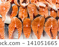 Fresh salmon fillets arranged on ice ready for sale at a seafood market 141051665