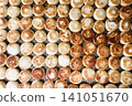 Freshly baked round bread rolls arranged neatly on a tray 141051670