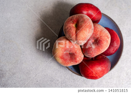 Bowl with ripe peach fruits on the table Bowl with ripe peach fruits on the table 141051815