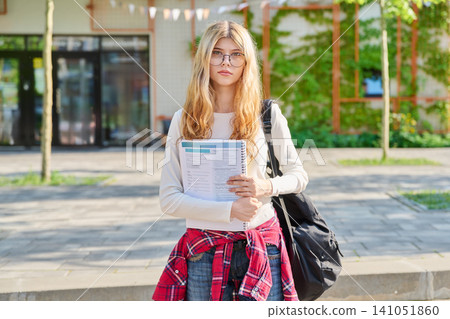 Teenage student girl in front of school building Teenage student girl in front of school building 141051860