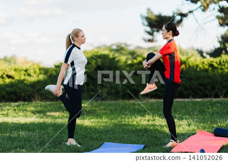 Women stretching in the park 141052026